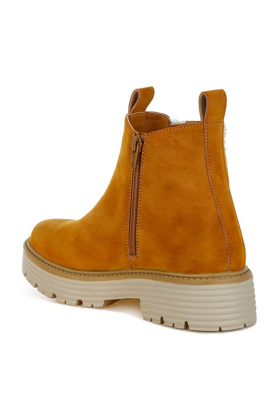 Back view tan ankle boots with center zipper and chunky treaded platform sole