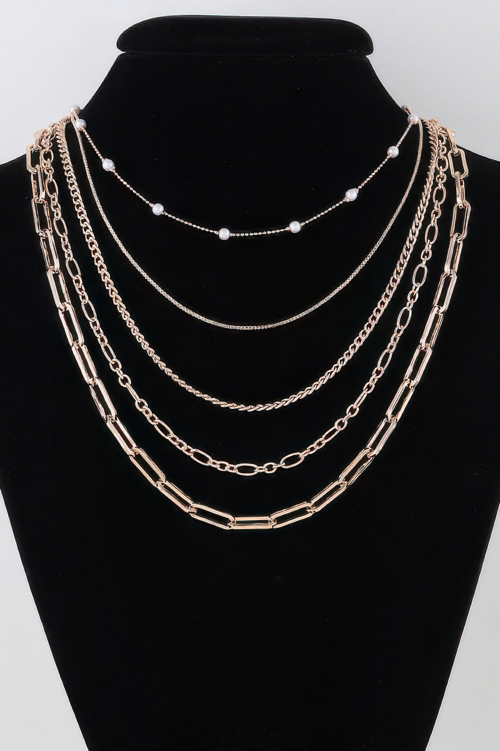 Multi chain drop necklace with gold-tone links and pearl-like bead drops