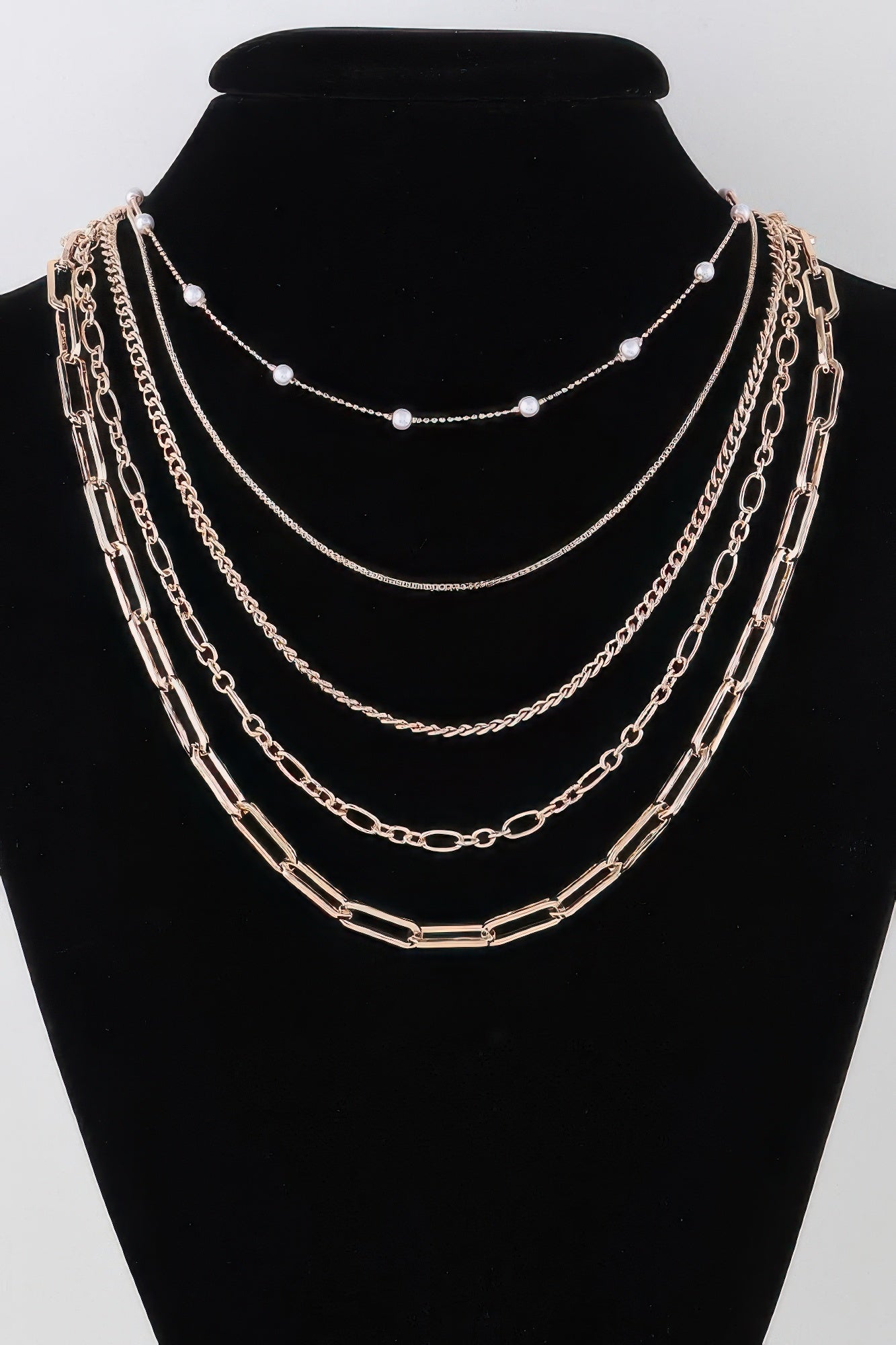 Multi chain drop necklace with gold-tone links and pearl-like bead drops