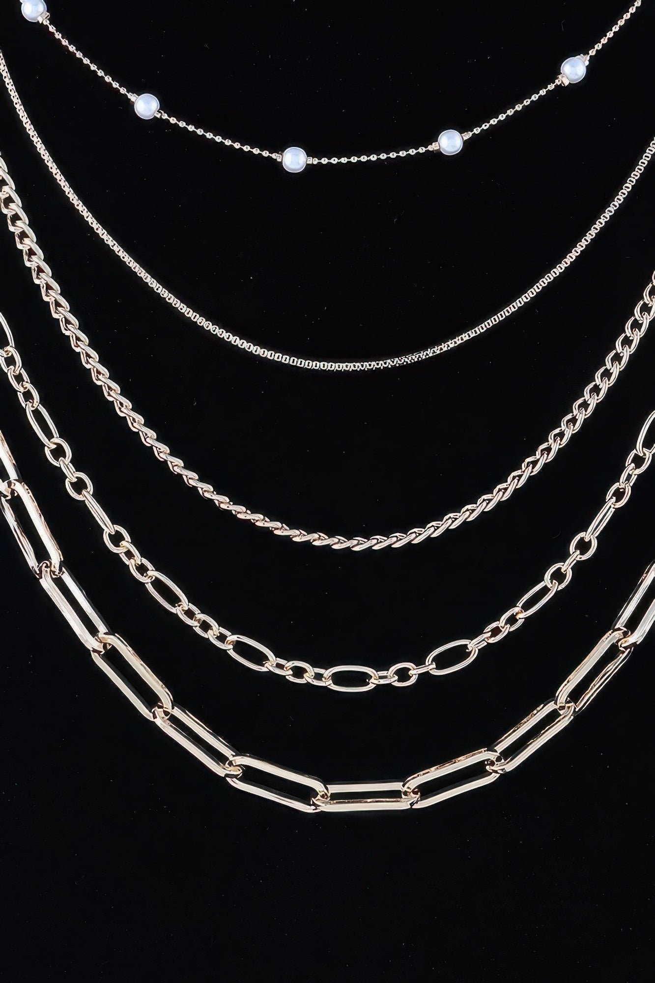 Layered gold-tone chain necklace with round bead accents and oval link strands