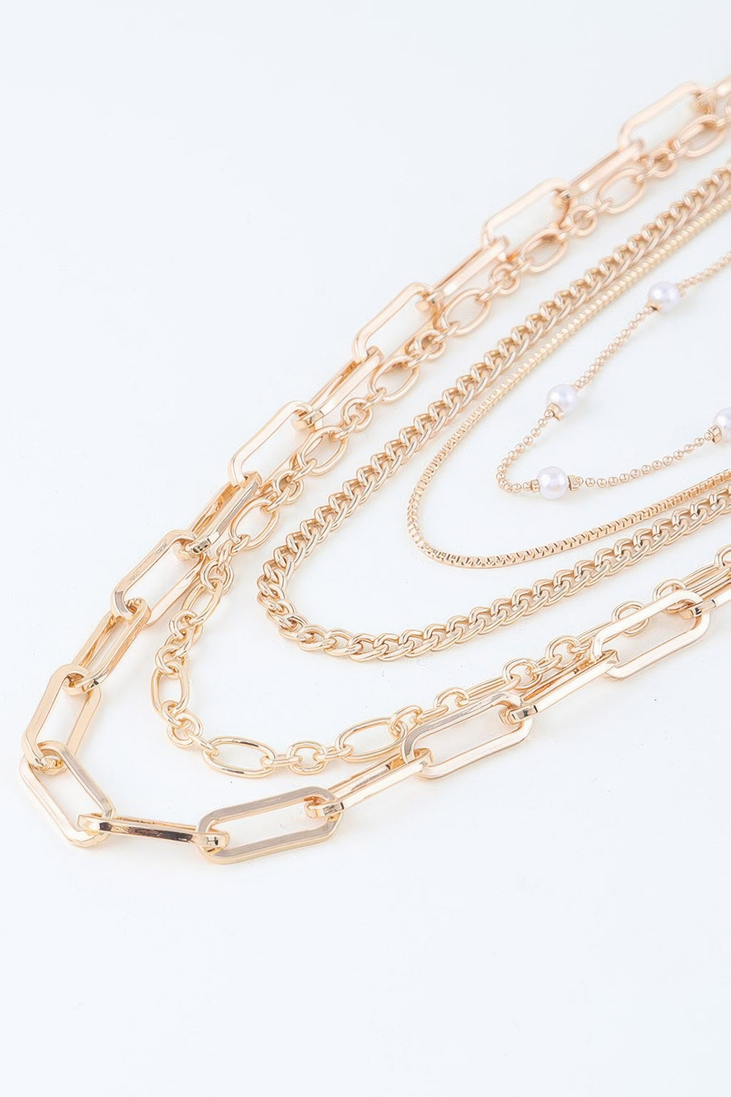 Close-up gold-tone chain drop necklace with rectangular links and dangling pearl beads