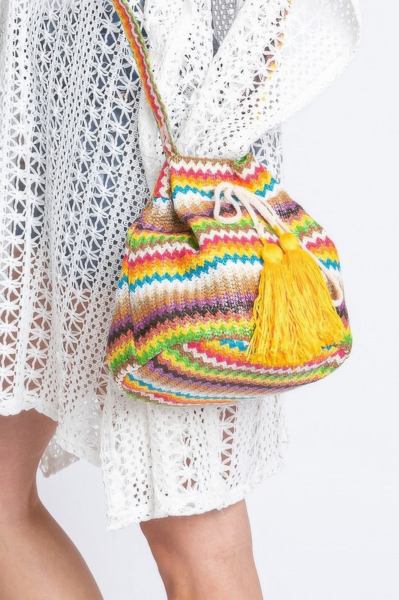 Multicolor chevron bucket bag, front view with yellow tassel drawstring