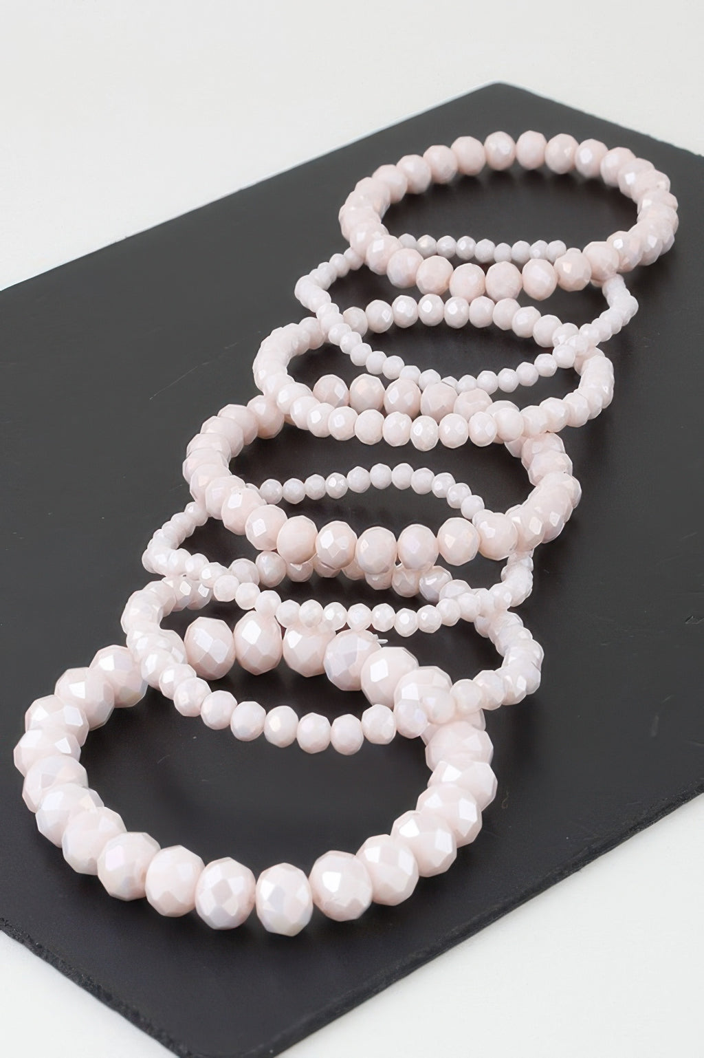 Multi crystal beaded bracelet with stacked light pink beads, oval beads pattern