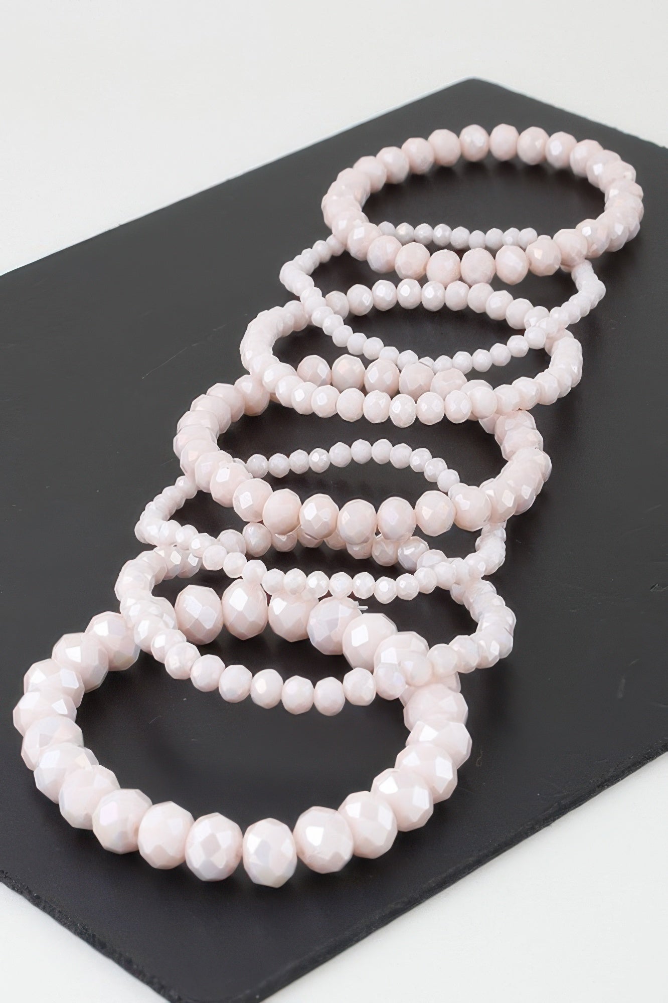 Multi crystal beaded bracelet with stacked light pink beads, oval beads pattern
