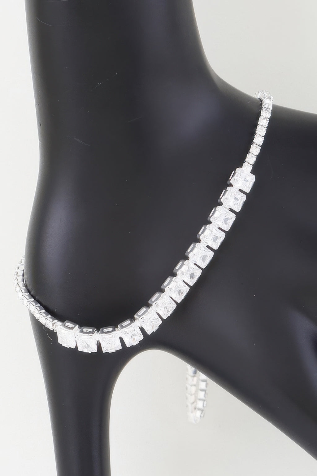 Silver-toned bracelet with clear, square cubic stones in a row and clasp detail