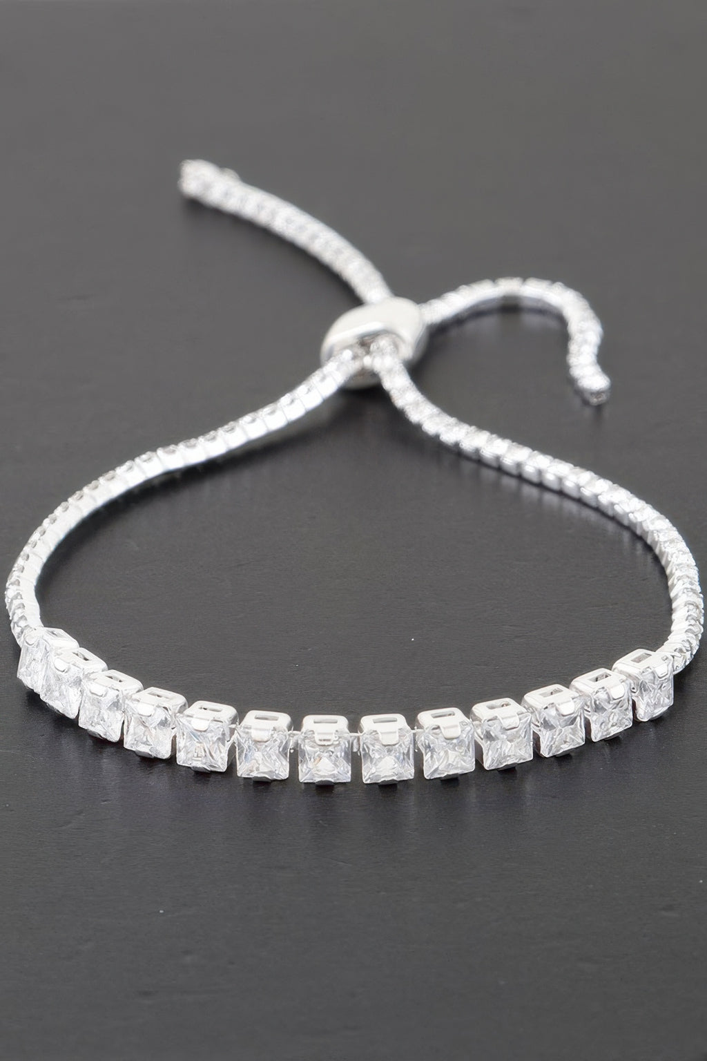 Silver-toned tennis bracelet with clear square cubic stones and a small open-link clasp