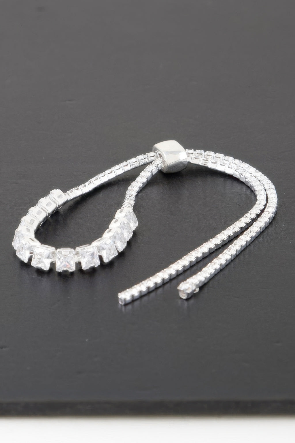 Silver-toned cubic-stone bracelet with clear square links and a single connector bead