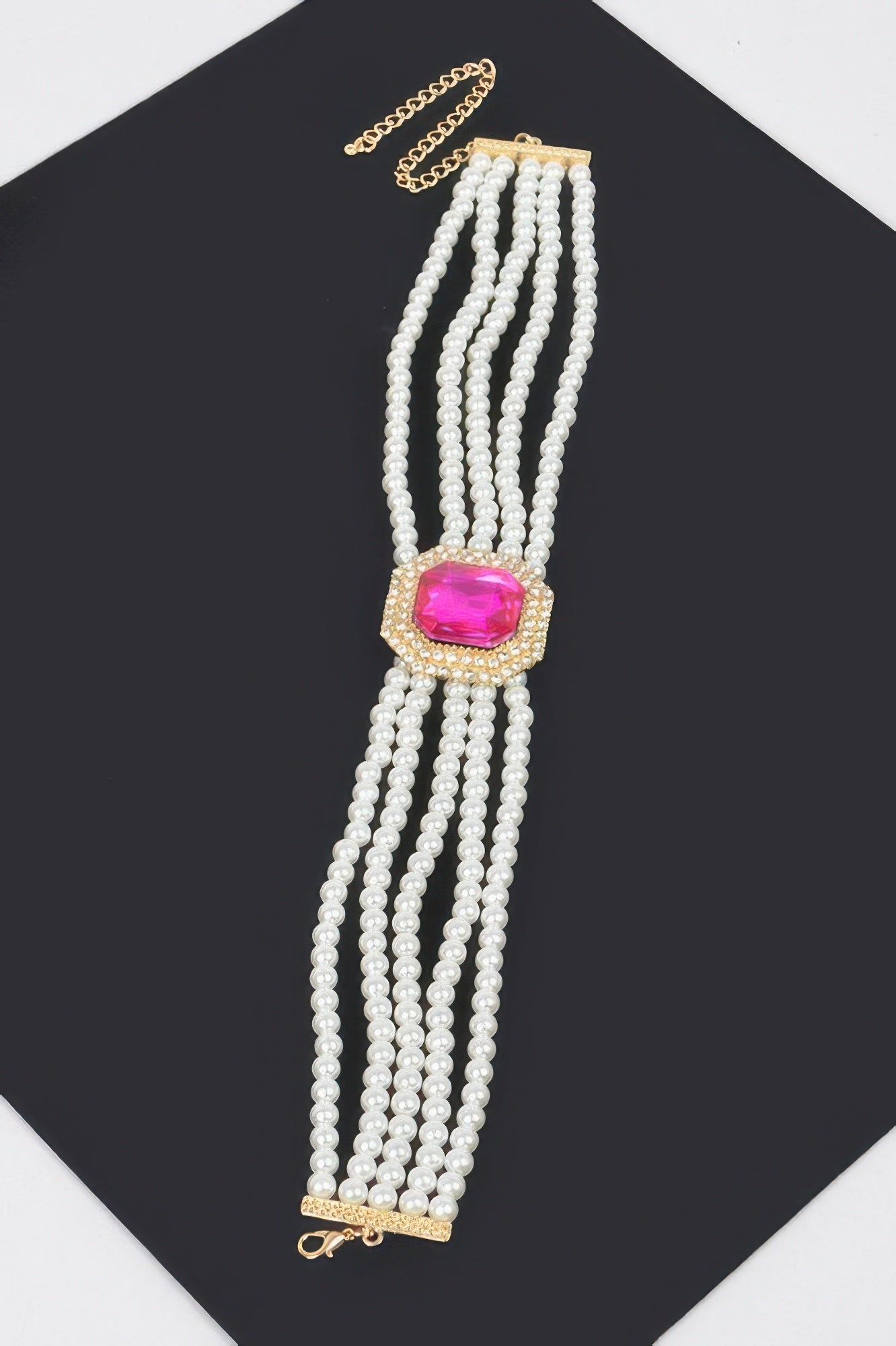 Cream faux pearl multi-strand necklace with pink gem pendant and gold chain