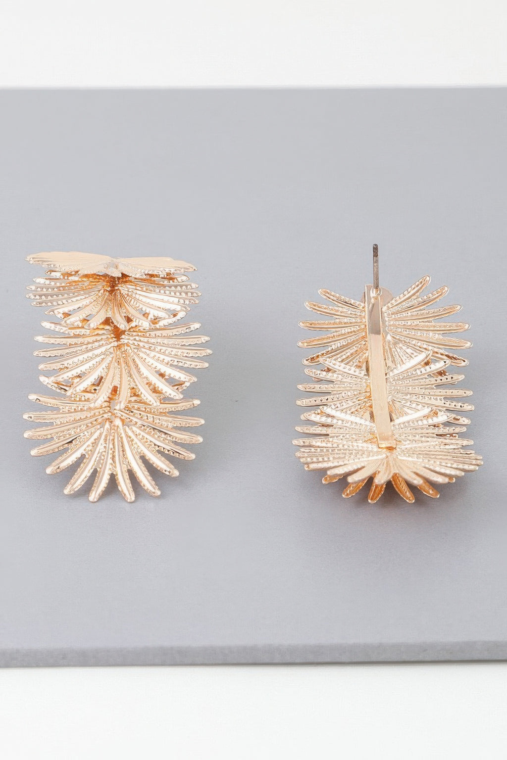 Gold multi-flare leaf drop earrings with stud post and layered leaf fan design