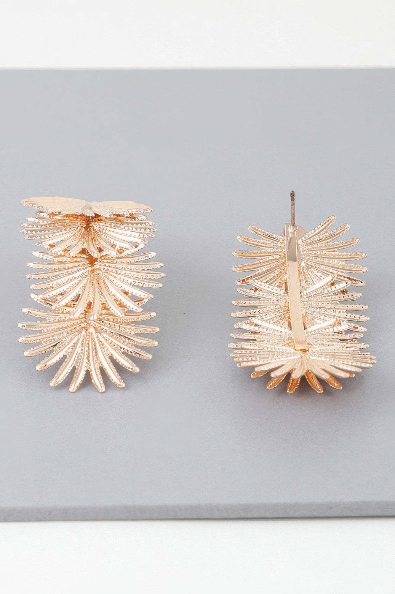 Gold multi-flare leaf drop earrings with stud post and layered leaf fan design