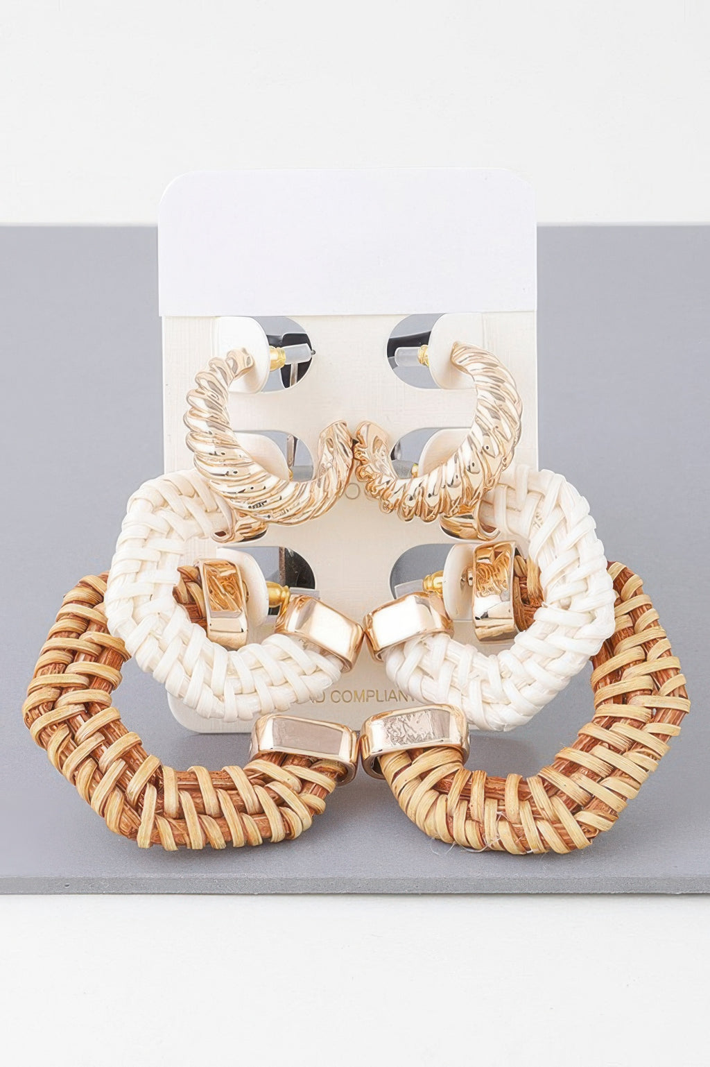 Natural multi woven hoop earrings set with gold-tone geometric stud ends, pair shown