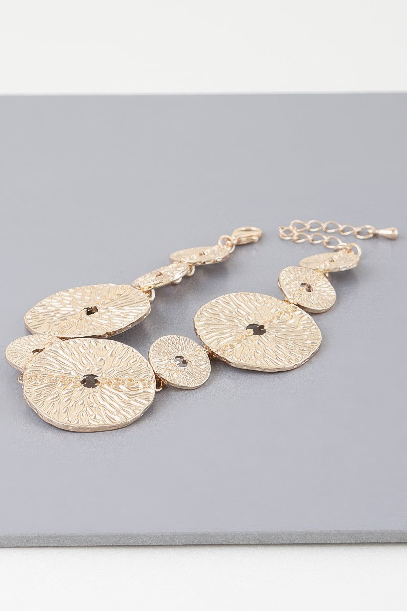 Hammered disc chain bracelet, oval discs with small dark center stones