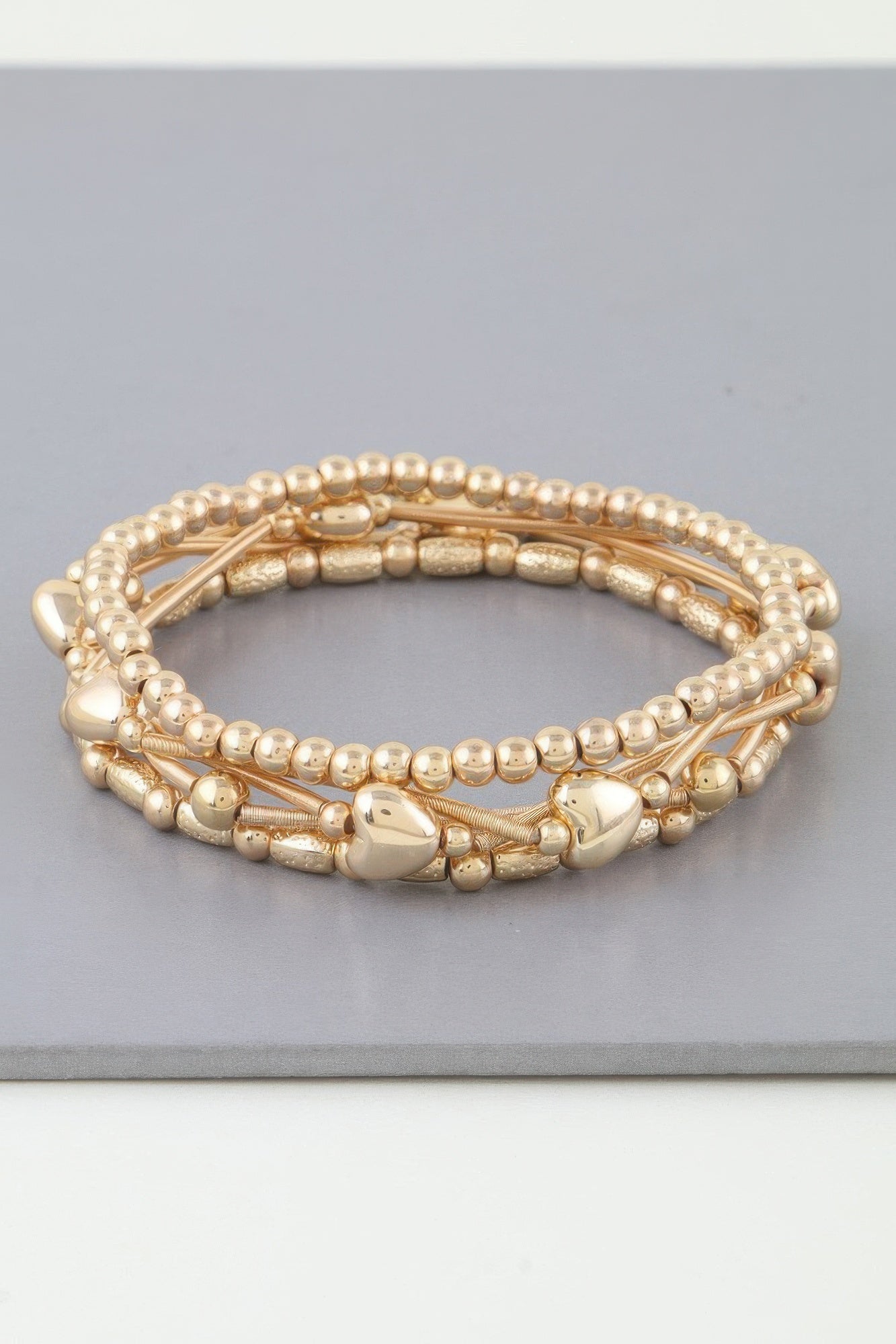 Multi Heart coil beaded bracelet stack (Gold) with heart charm accents