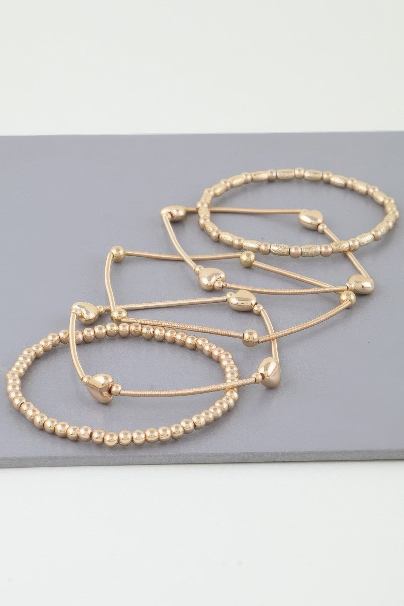 Multi Heart Coil Beaded Bracelet set (Gold) with heart-shaped beads on metal bands