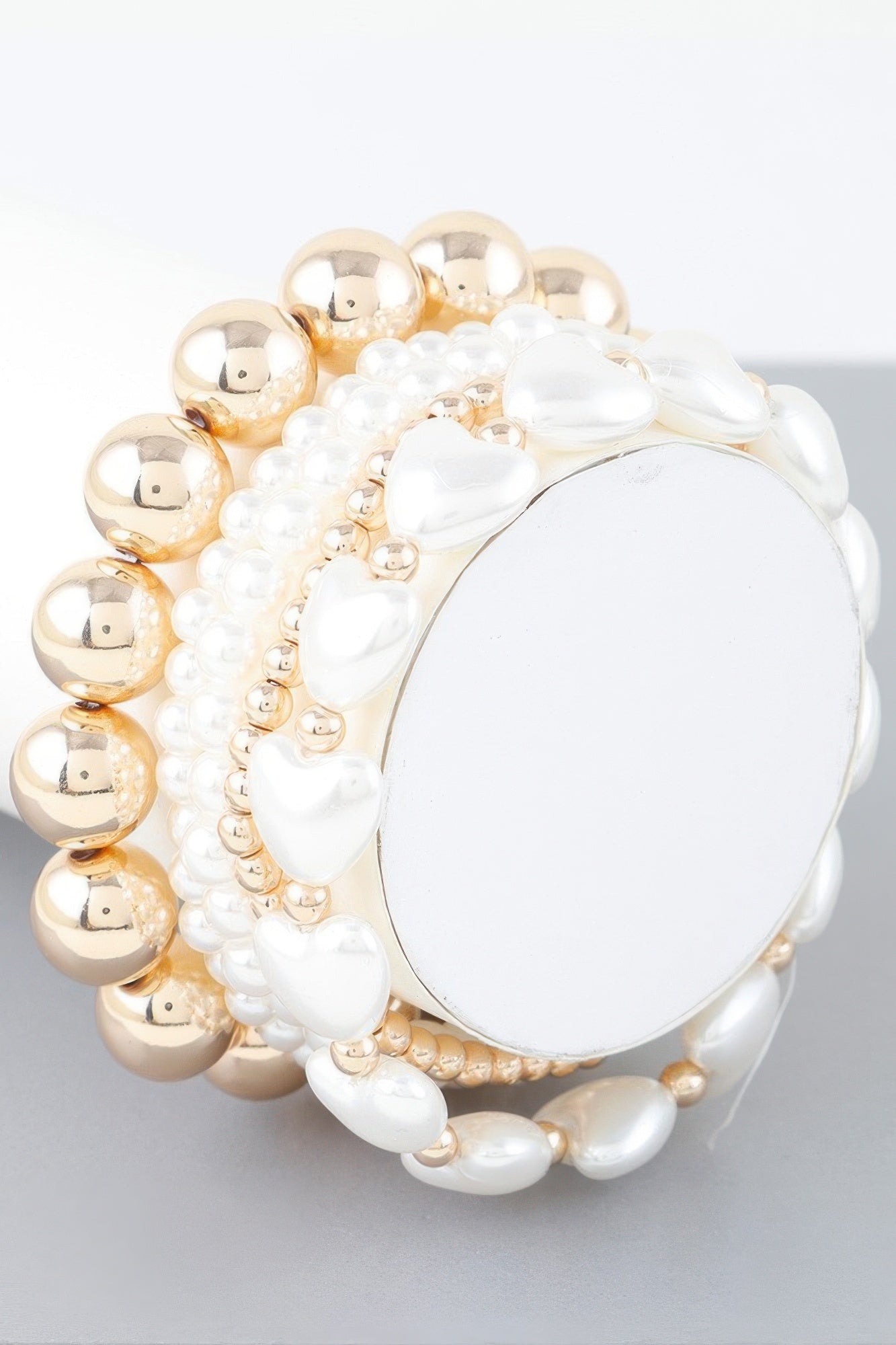 Gold-cream beaded bracelet with white heart stone centerpiece