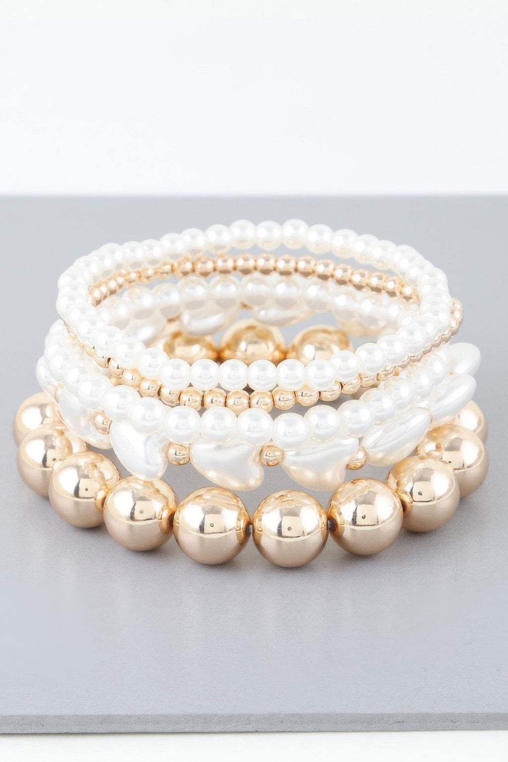 Layered pearl and gold-bead bracelet with three rows