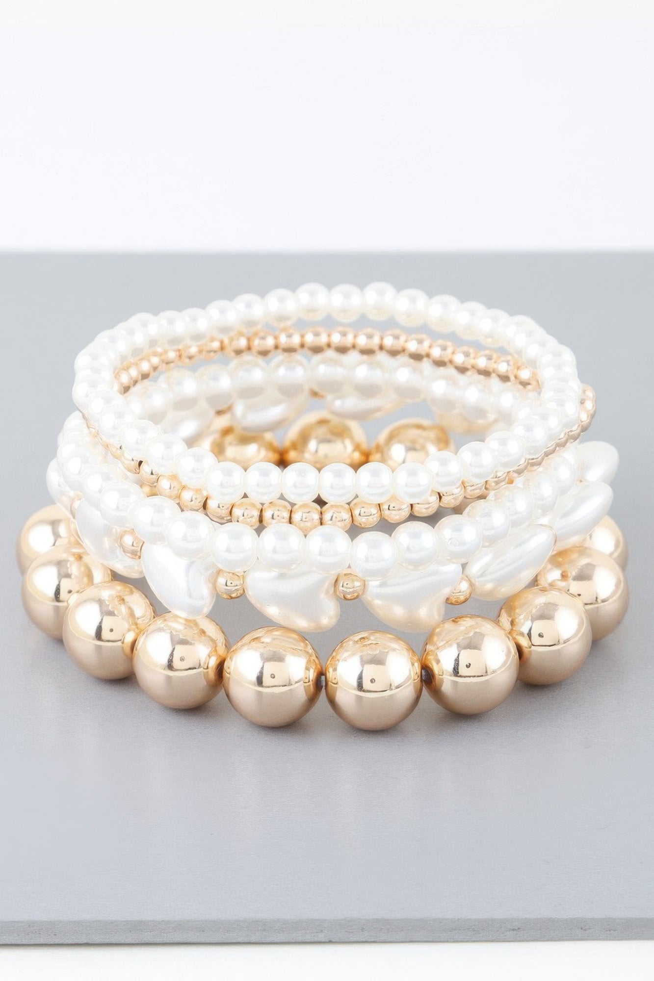 Layered pearl and gold-bead bracelet with three rows
