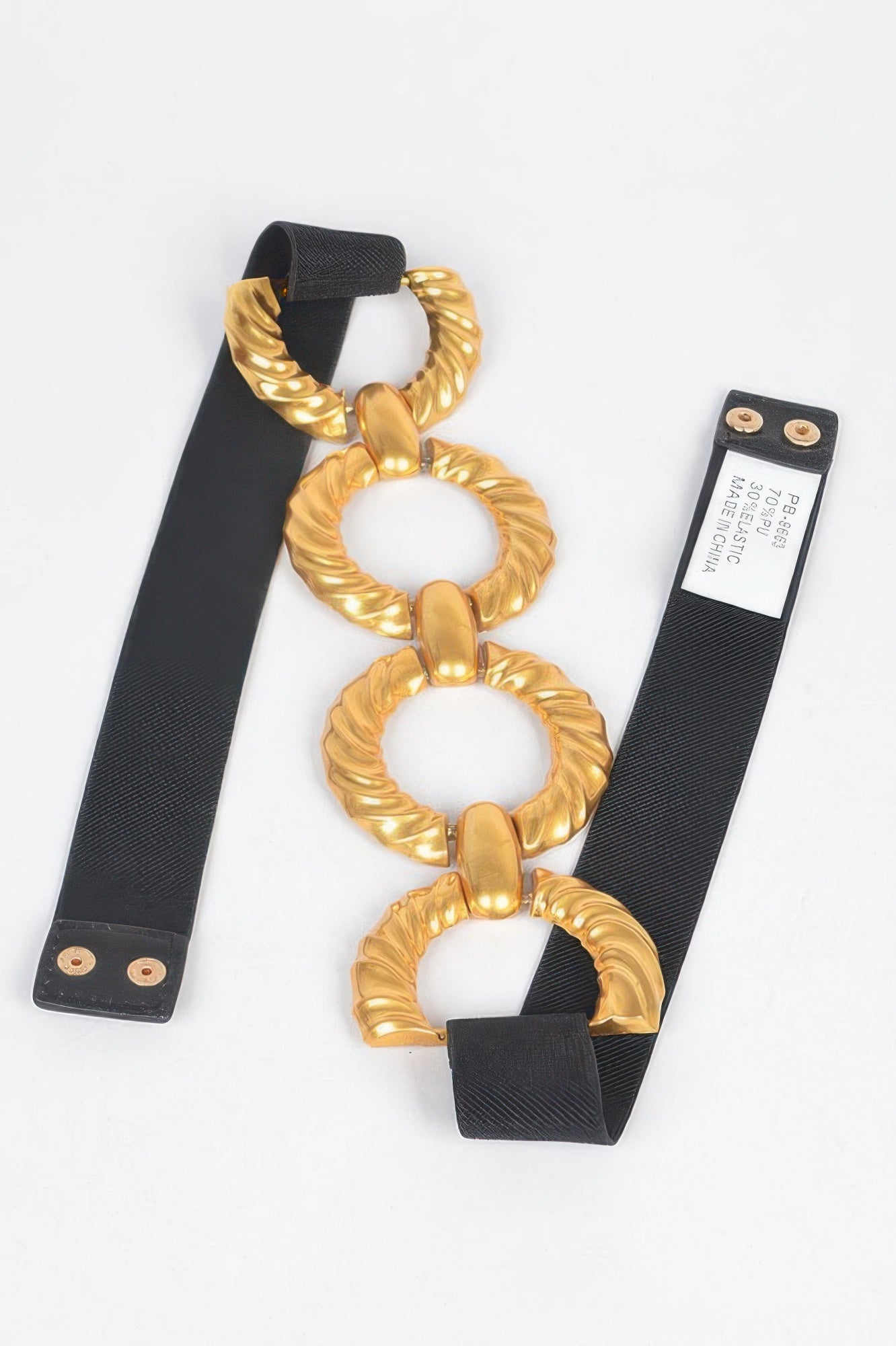 Black elastic belt with gold chain-link buckle and attached tag