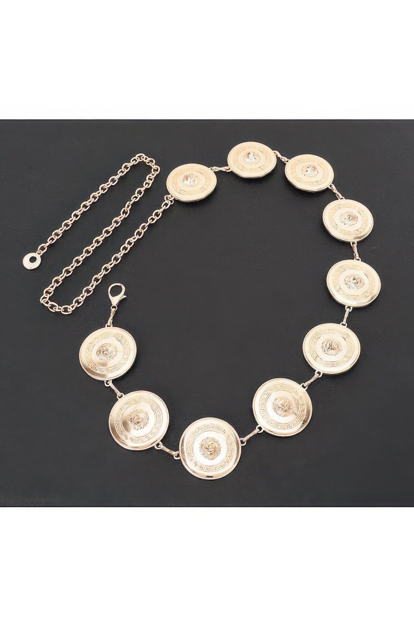 Gold round coin chain belt with linked medallions, flat lay