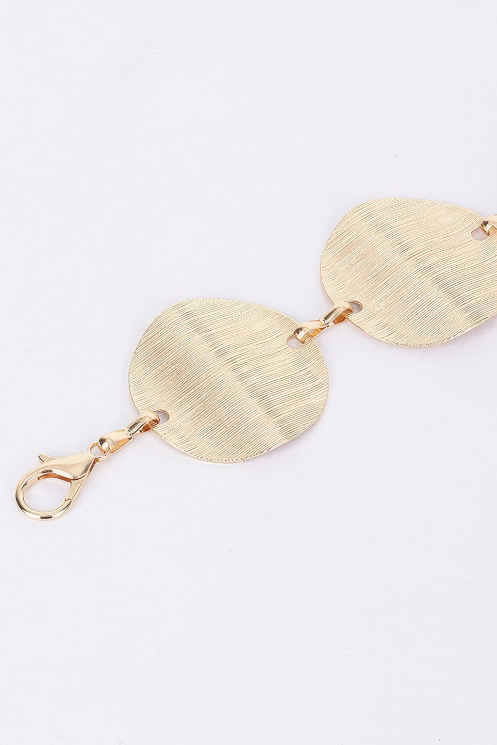 Gold oval disc chain belt detail with lobster clasp and jump rings