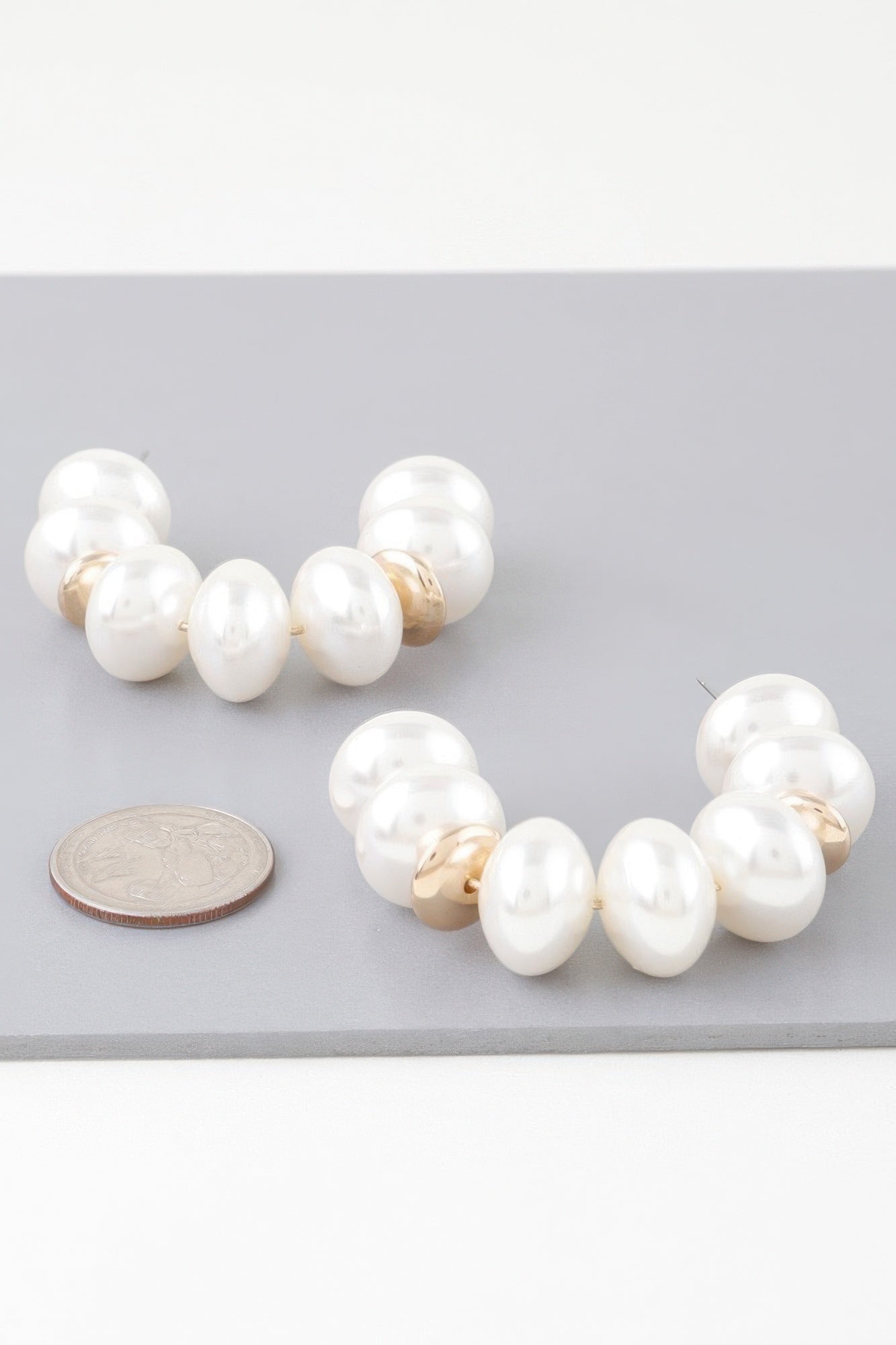 Multi-oval pearl hoop earrings with gold-tone links and white oval pearls