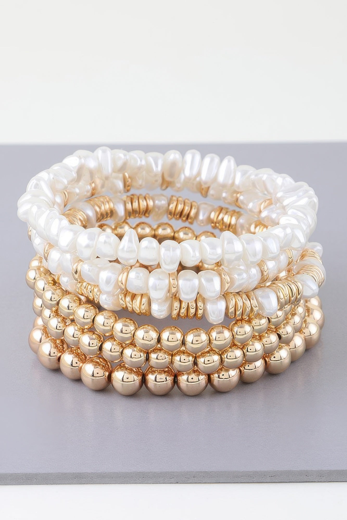 Multi pearl beaded bracelet with white pearls and gold-tone bead rows