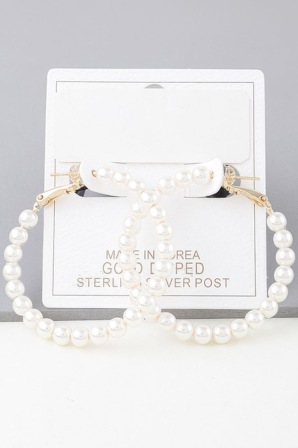 Pearl hoop earrings with gold-tone hooks and cream pearls