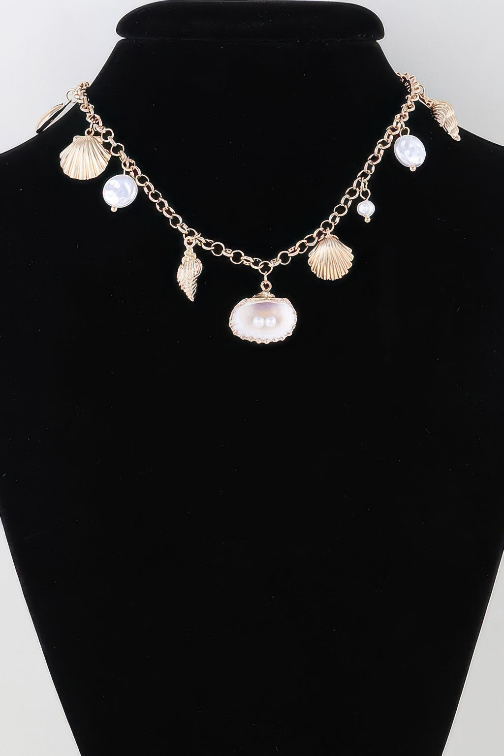 Gold pearl and shell charm necklace with fan, oval, and pearl drop charms
