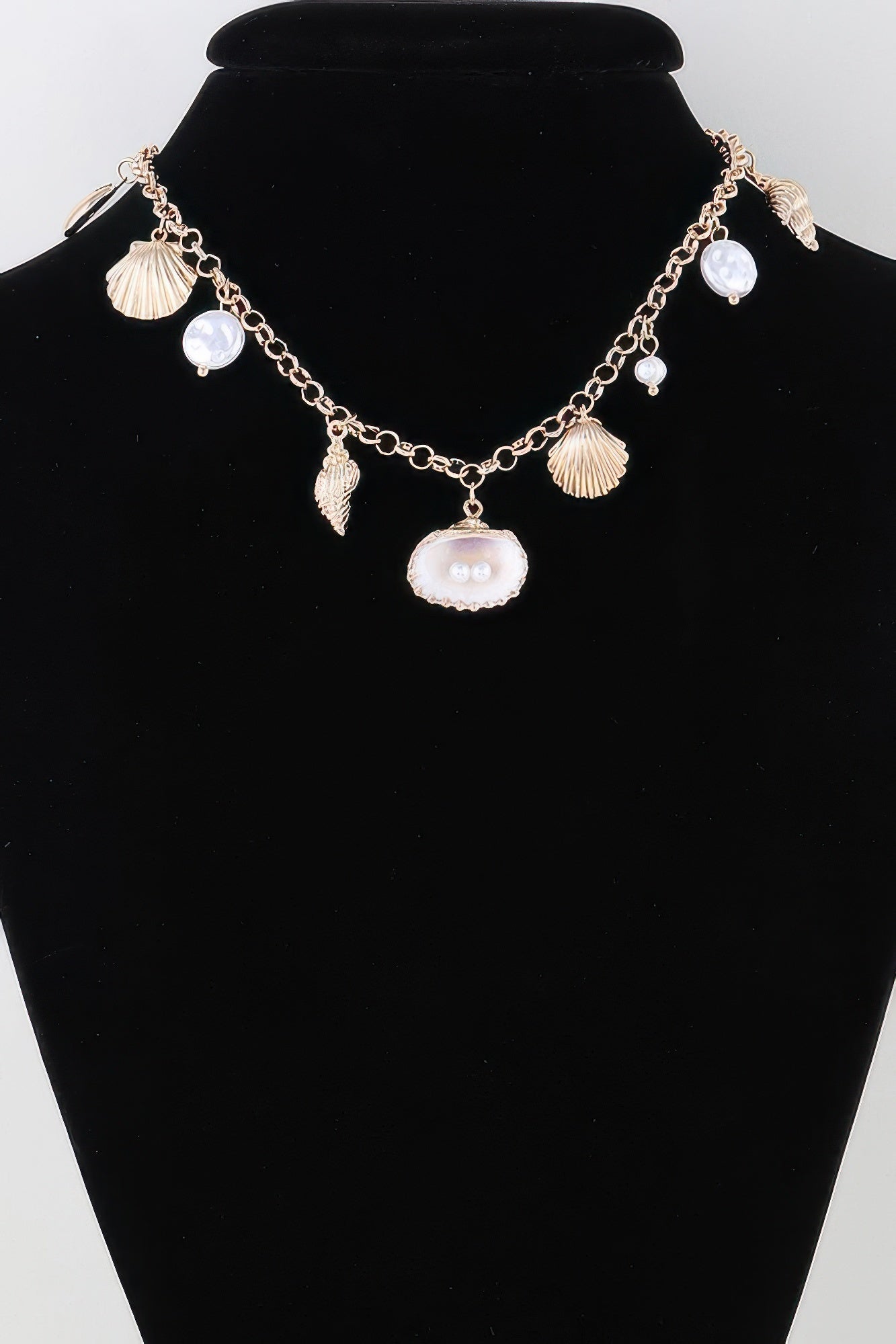 Gold pearl and shell charm necklace with fan, oval, and pearl drop charms