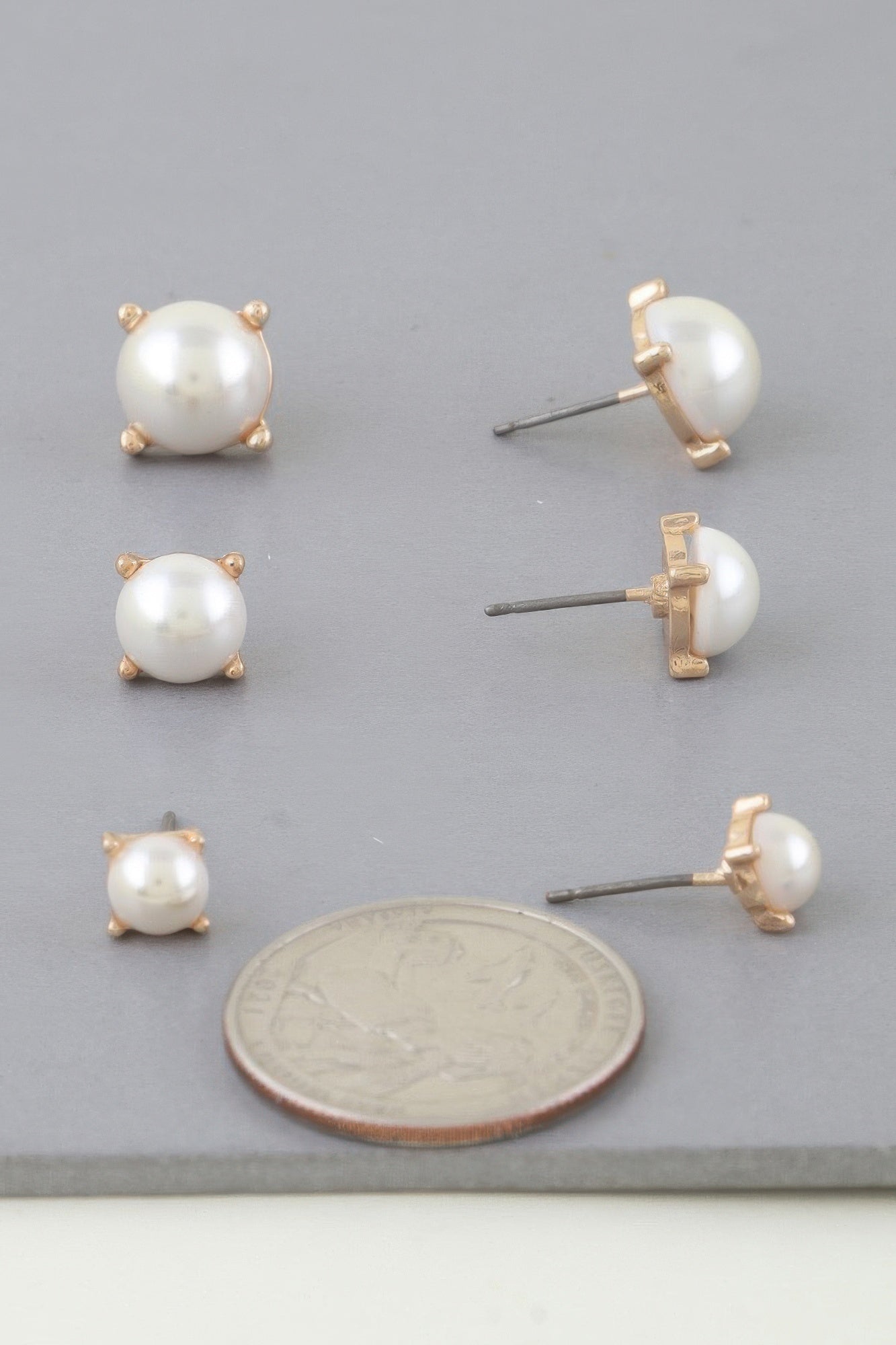 Cream pearl stud earring set with gold-tone backs, small and medium round pearl studs