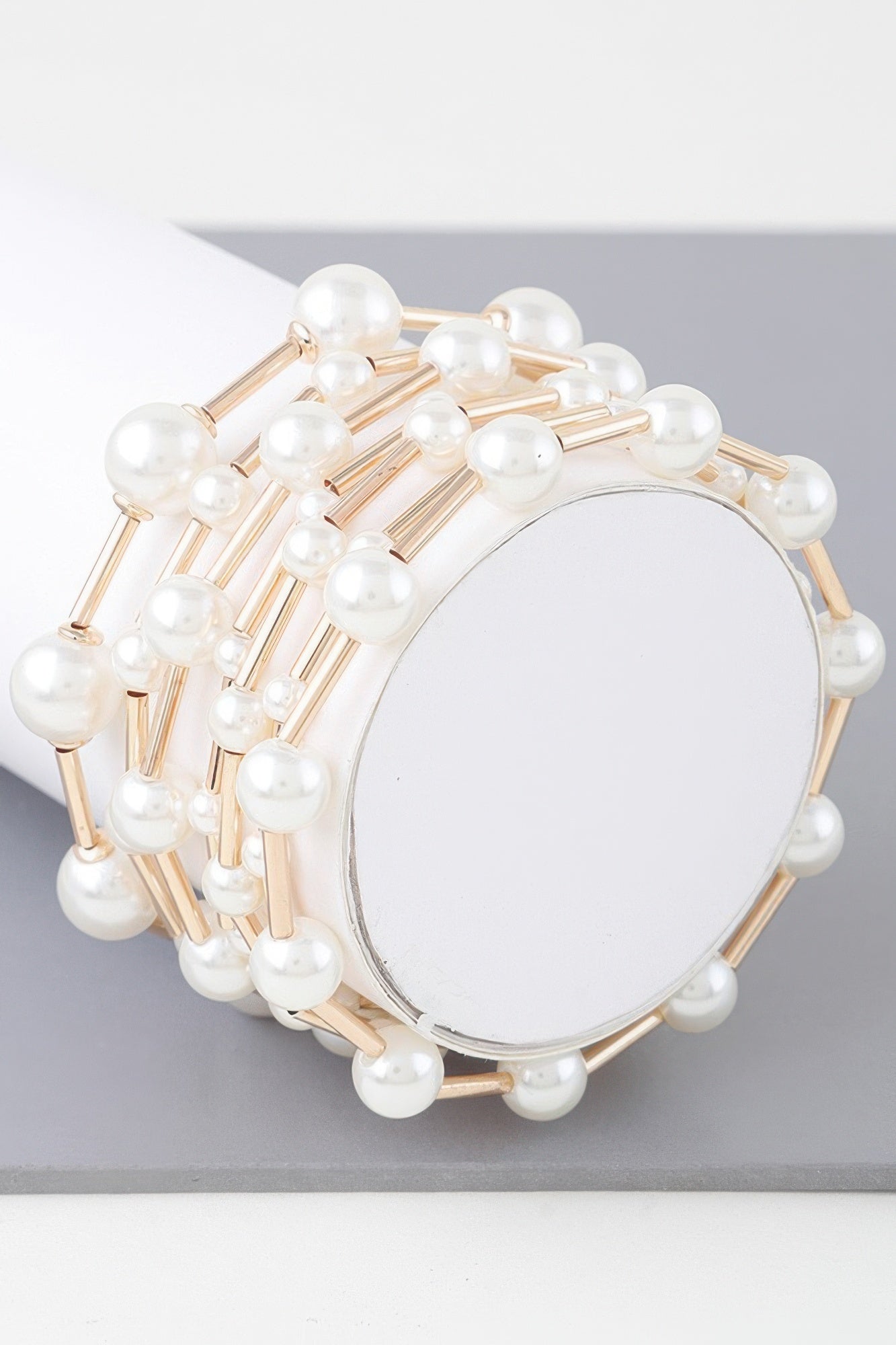 Multi pearl wire bracelet with round white pearls and gold-tone metal frames