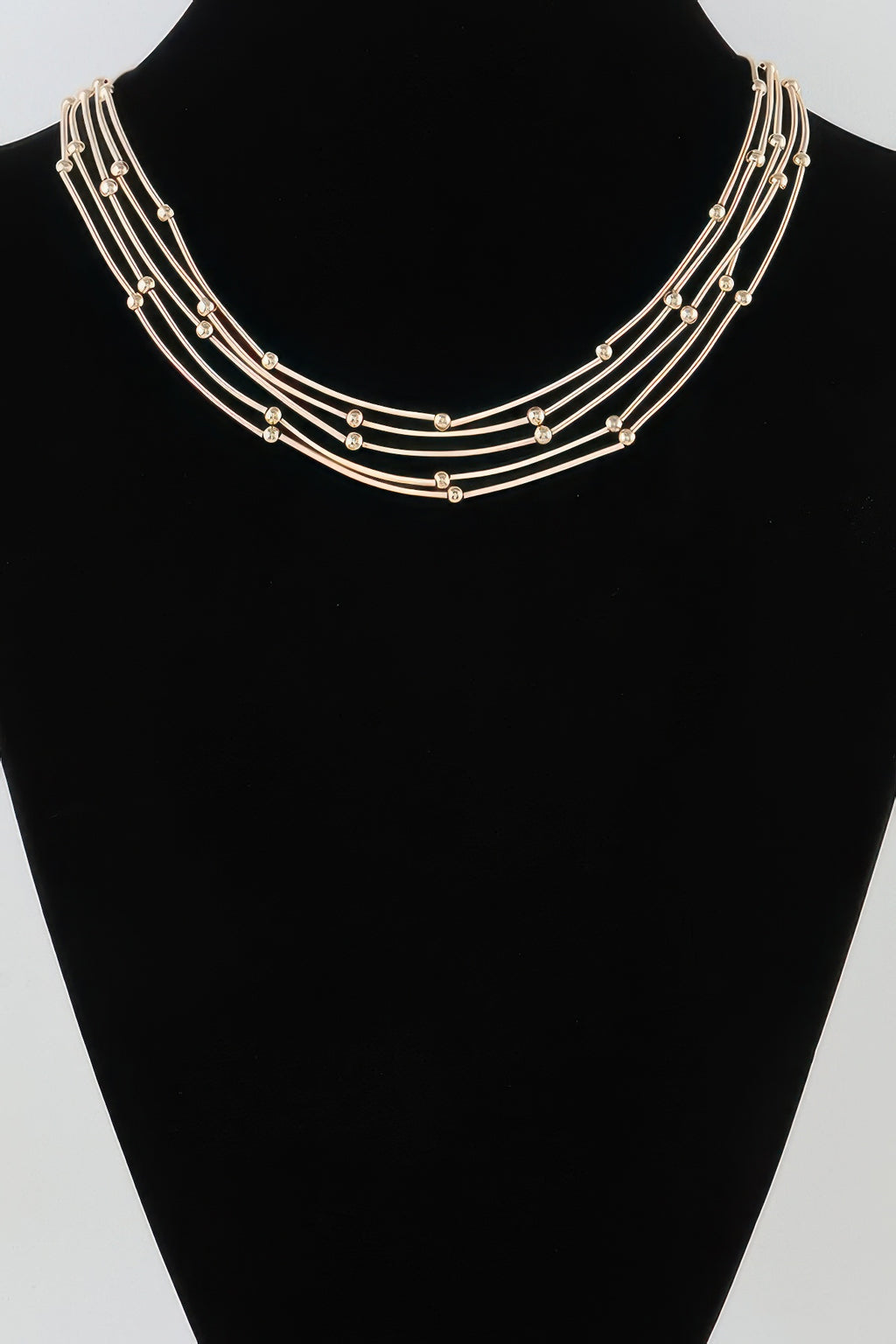 Multi pillar beaded necklace, gold-tone strands with small bead accents on a collar