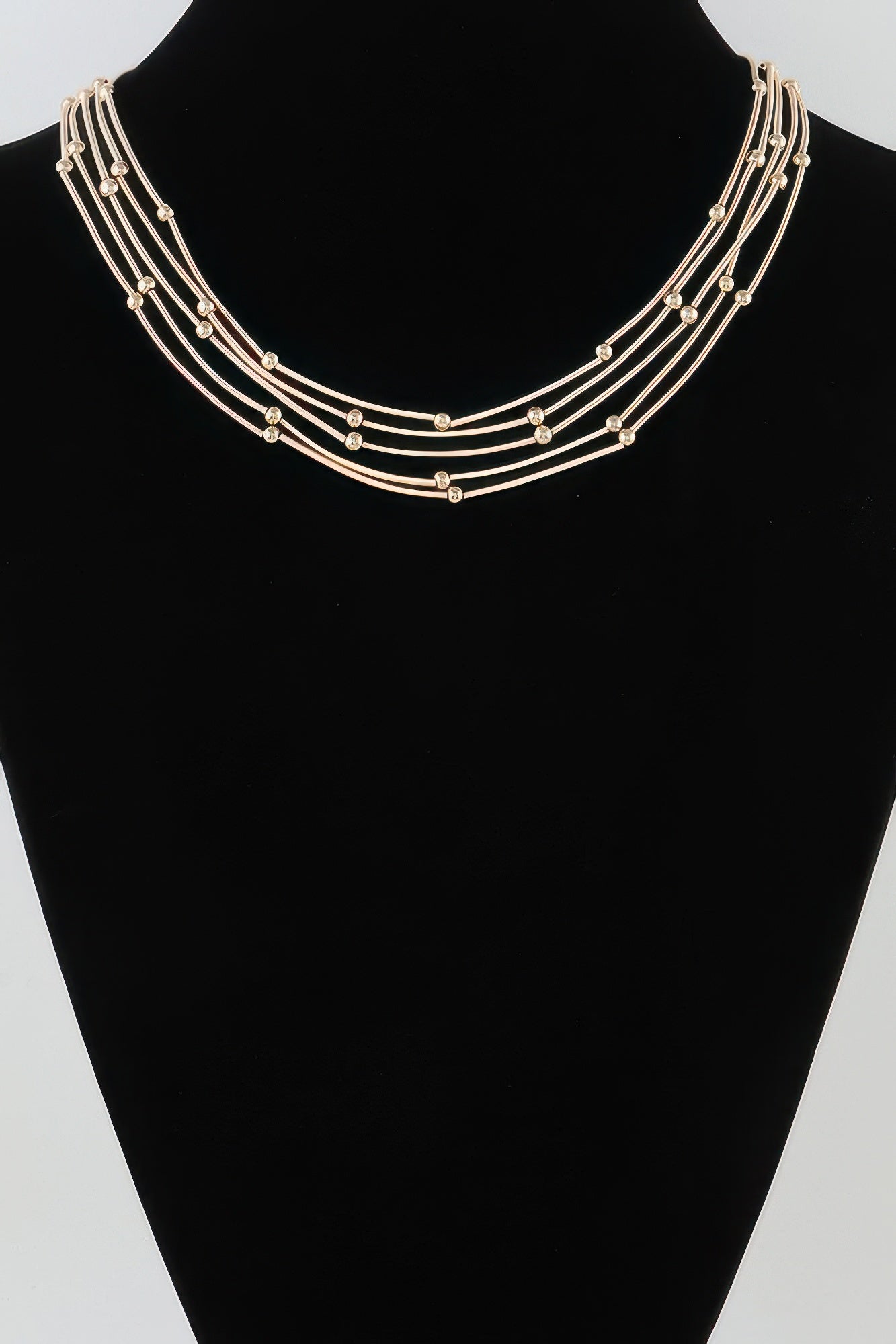 Multi pillar beaded necklace, gold-tone strands with small bead accents on a collar