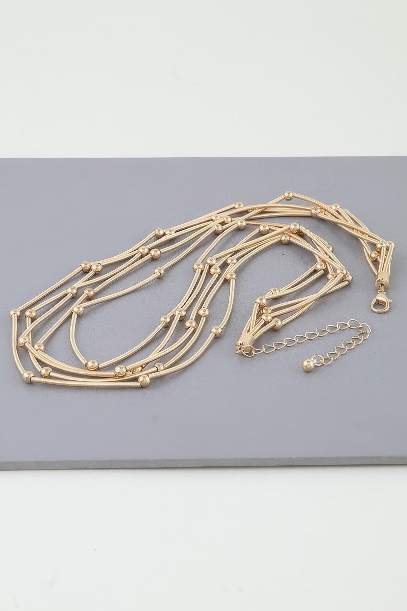 Multi pillar beaded necklace, gold-tone multi-strand design with round bead accents