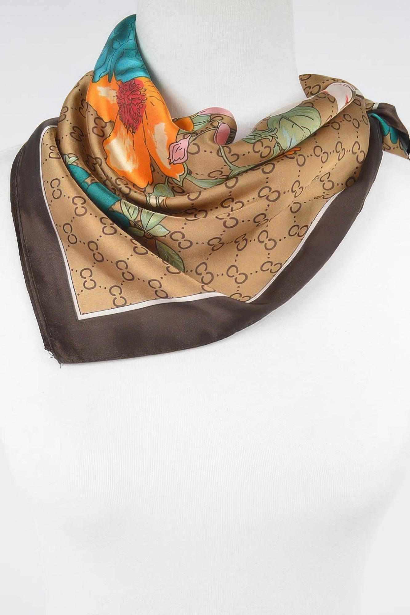 Multi print bandana draped, beige print with orange and teal flowers; dark border