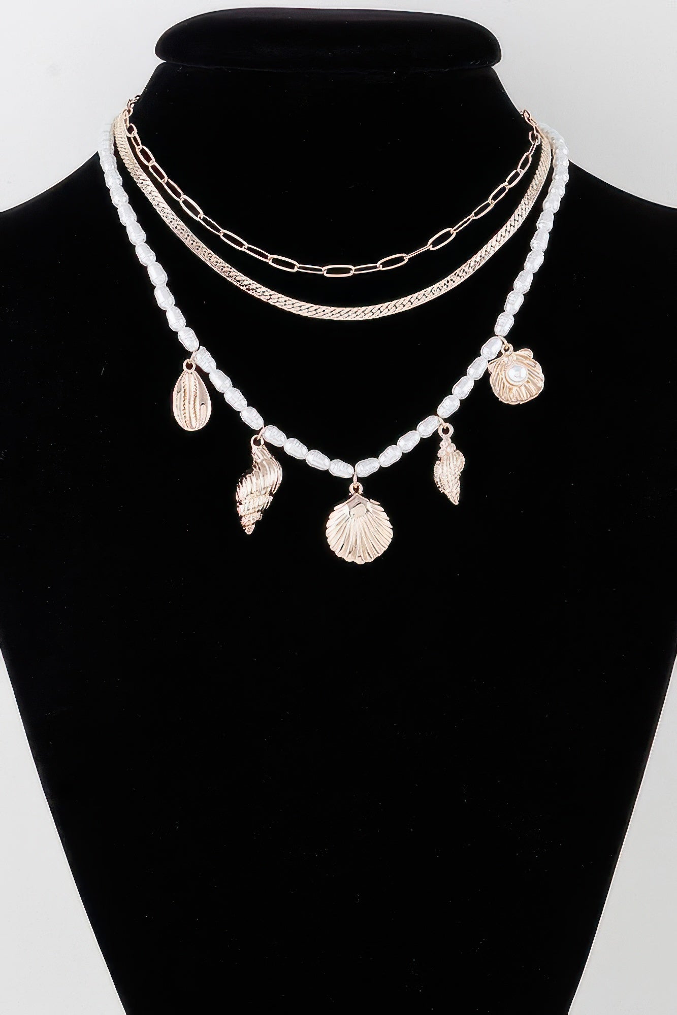 Multi Seashell Charm Necklace with white bead strands and gold shell pendants