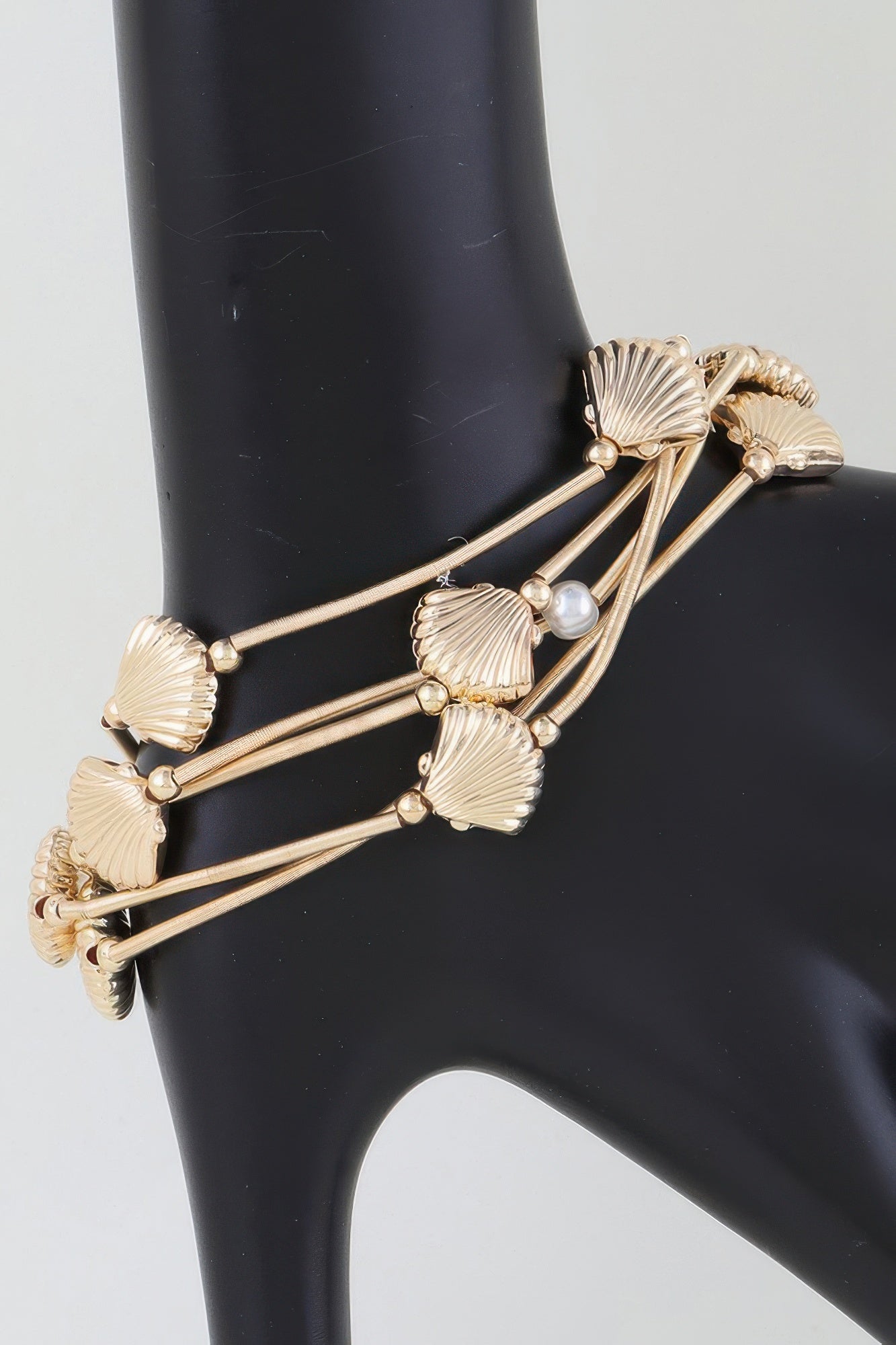 Gold multi-coil seashell bracelet with pearl beads and ribbed shell charms