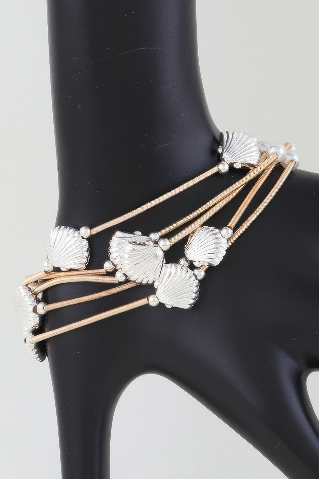 Gold-and-silver multi-coil seashell bracelet with pearl beads and shell charms