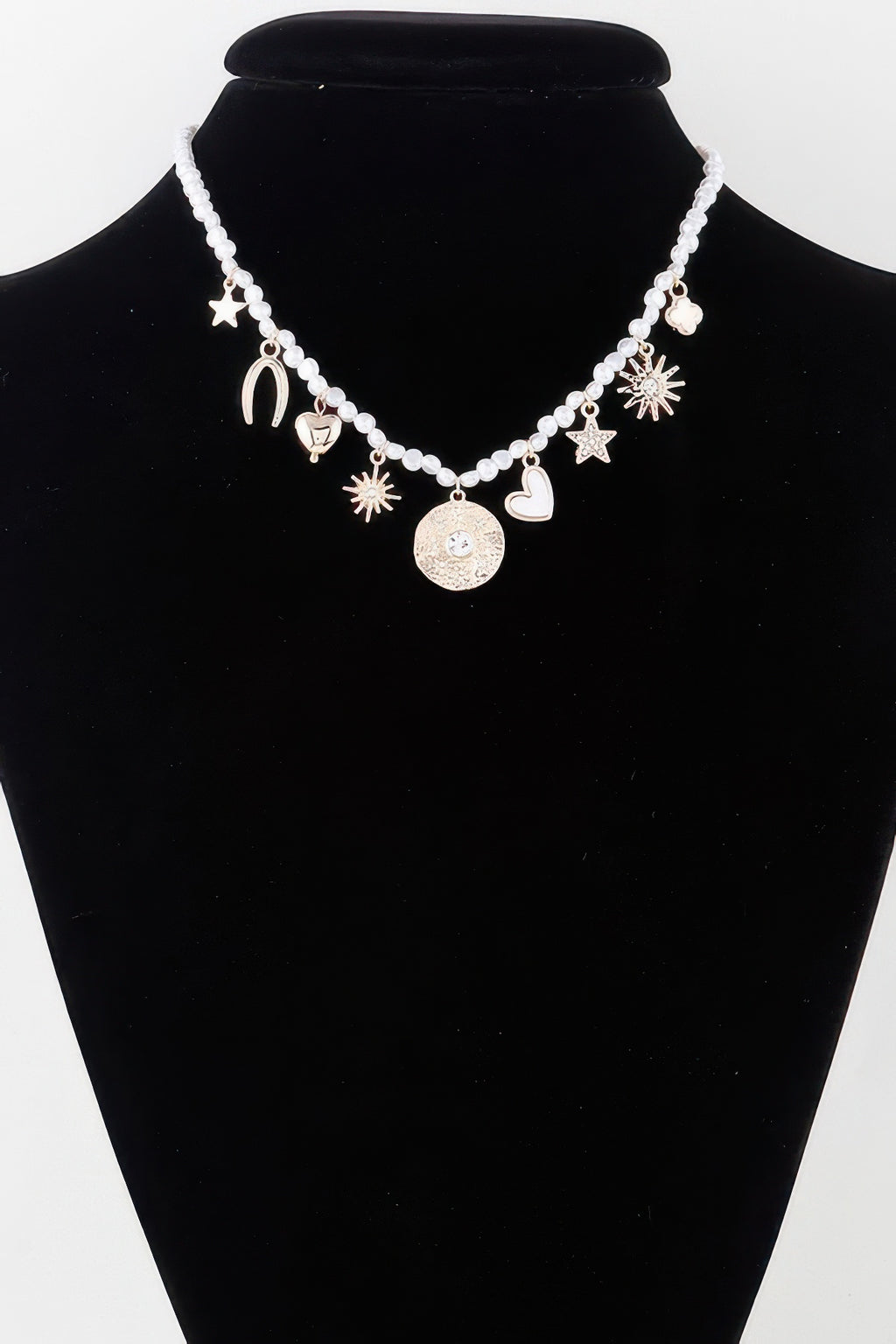 Beaded necklace with shiny charms: stars, hearts, moons and sunburst dangles
