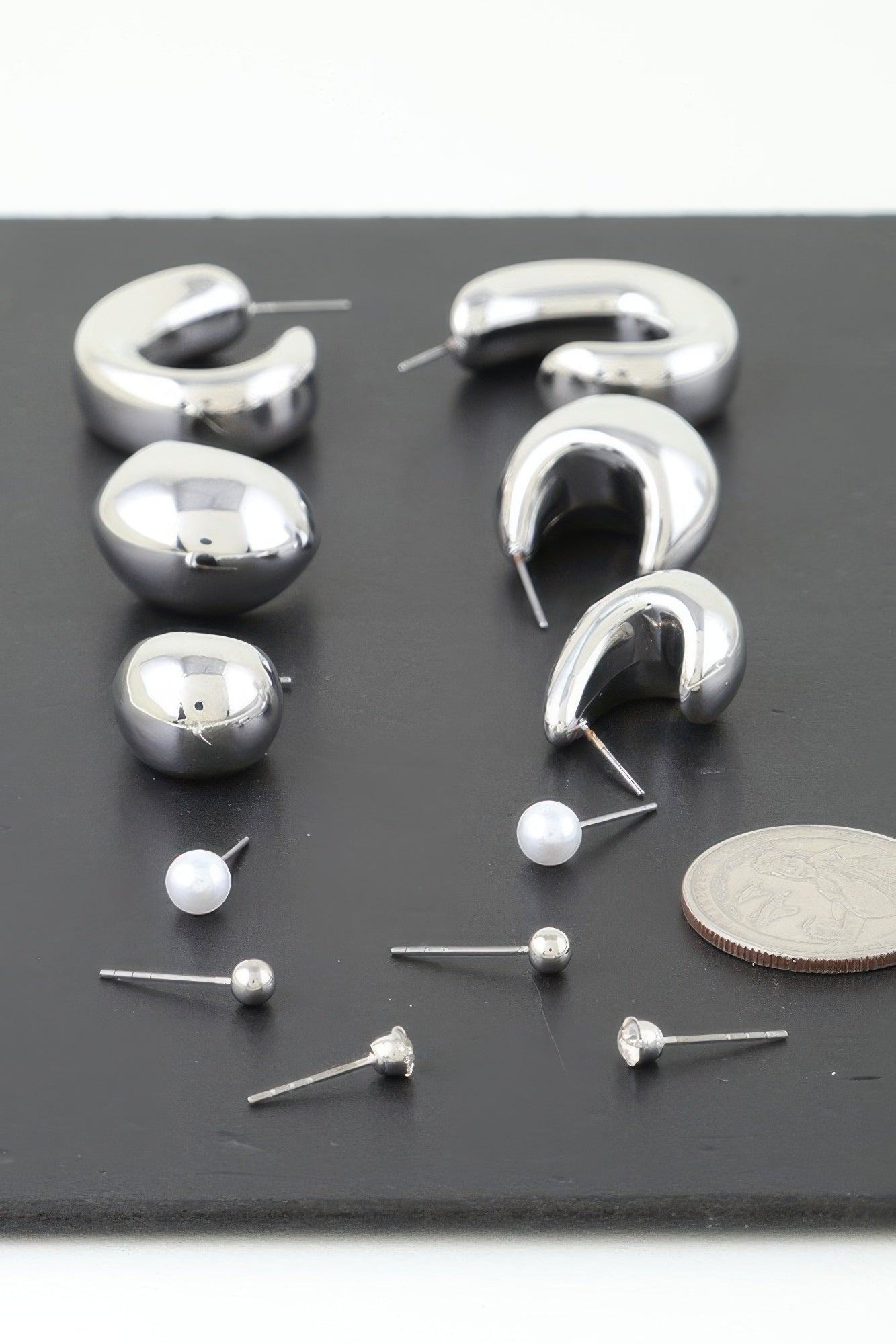 Assorted silver hoop earrings with pearl bead studs and hook backs