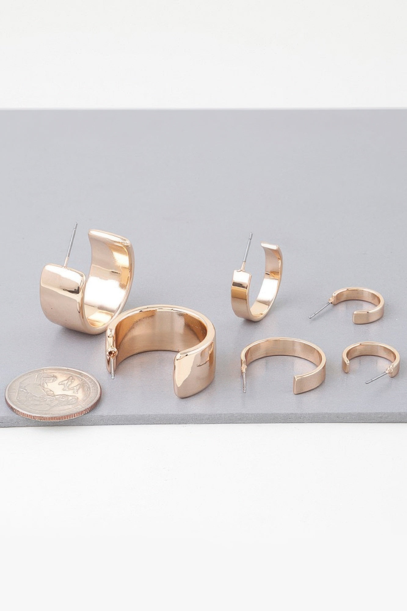 Gold modern hoop earrings set with open C-shape hoops and straight posts