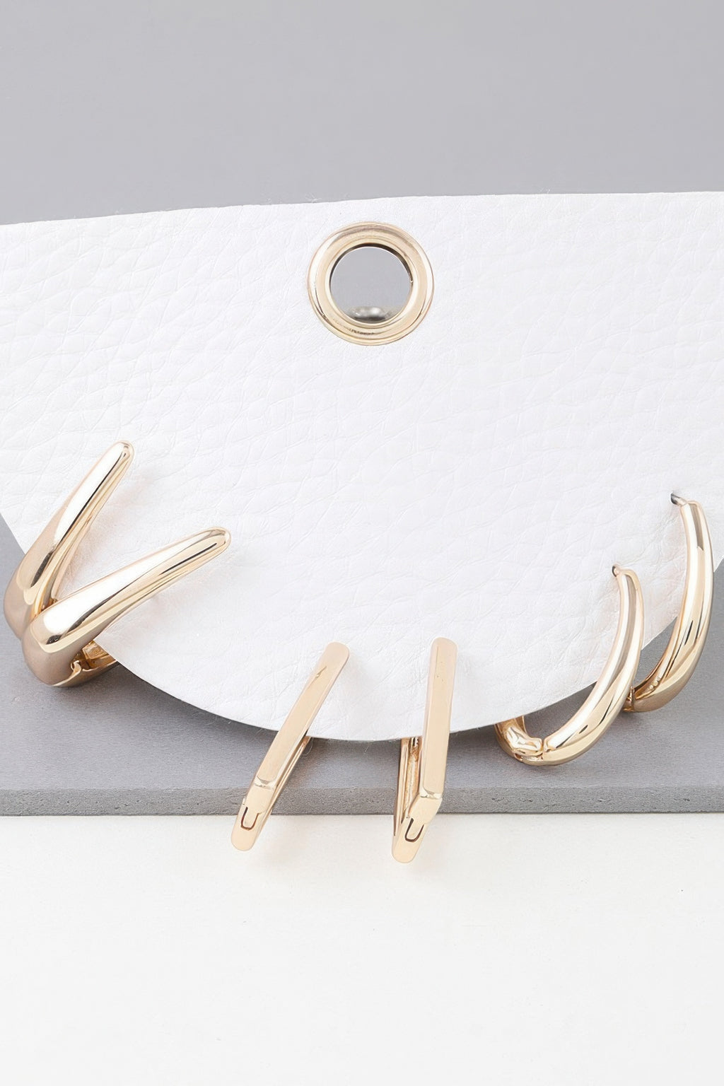 Shiny modern hoop earrings set, gold finish, multiple curved hoops