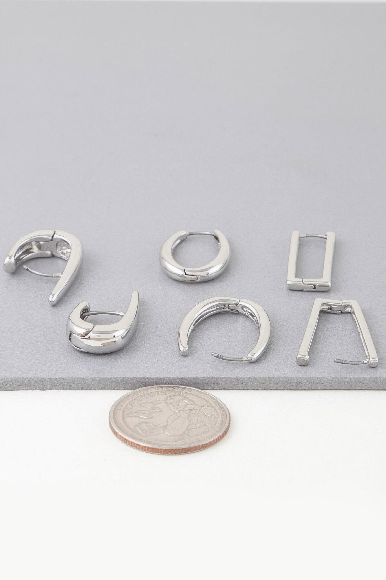 Shiny hoop earrings set in silver, assorted modern shapes with closures