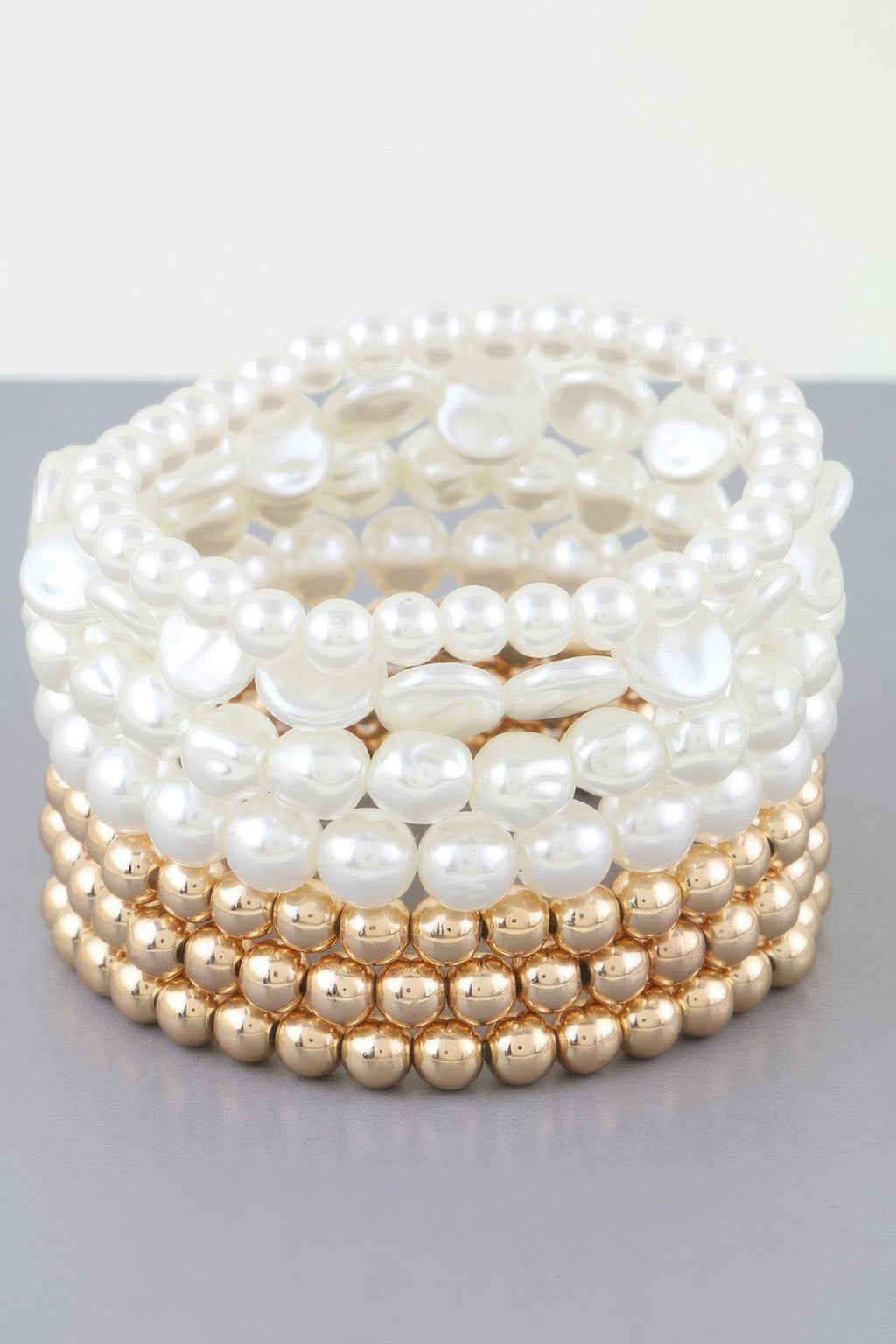 Multi Stone Beaded Bracelet: layered cream pearl rows with gold-tone bottom band