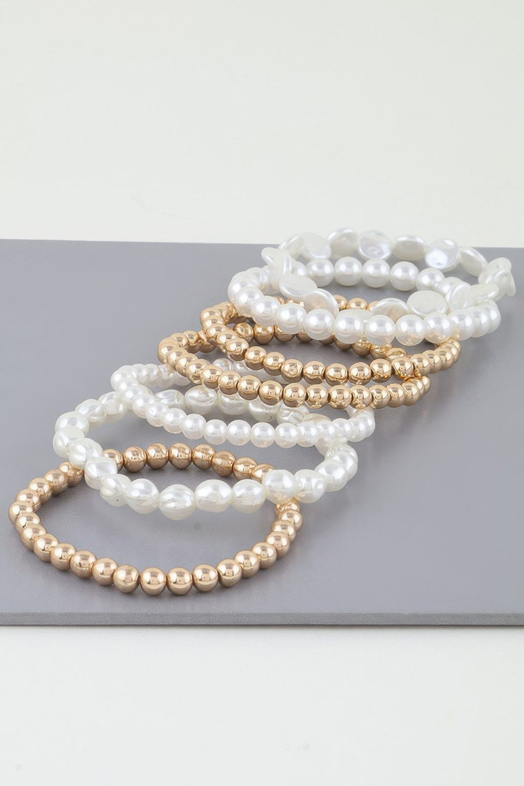 Multi Stone Beaded Bracelet with white pearls and gold-tone beads in stacked strands