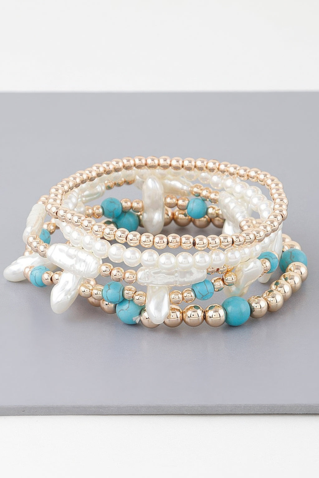 Stacked multi-strand bracelet: white pearls, turquoise beads, gold-tone round beads
