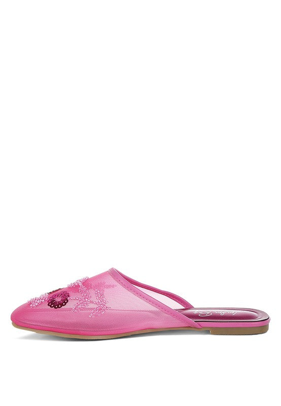 Fuchsia slip-on mule with beaded sequin flowers across the mesh upper