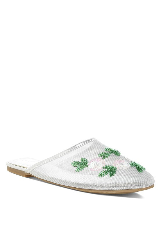 White mesh mule with green sequin clover detailing across toe, slip-on
