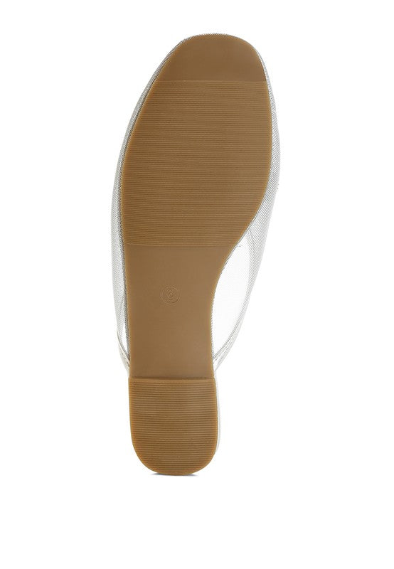 Light tan mule outsole with textured tread and flat rubber sole