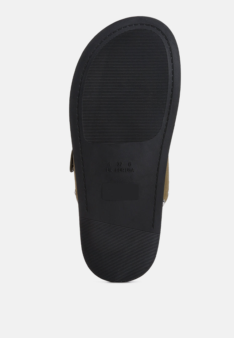 Black sandal outsole with textured tread and embossed brand marking